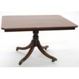 A VICTORIAN STYLE MAHOGANY BREAKFAST TABLE ON TURNED PEDESTAL BASE AND BRASS CASTORS, 75CM H; 105