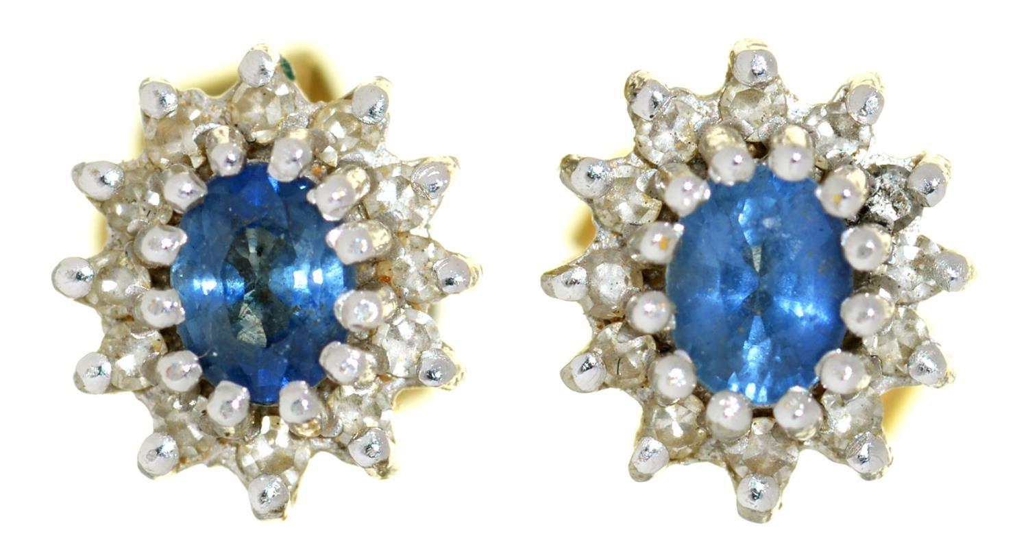 A PAIR OF TANZANITE AND DIAMOND CLUSTER EAR STUDS 7MM D, IN GOLD, MARKED 750, 2.3G Good condition