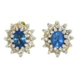 A PAIR OF TANZANITE AND DIAMOND CLUSTER EAR STUDS 7MM D, IN GOLD, MARKED 750, 2.3G Good condition