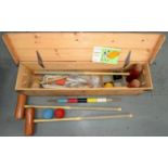 A CROQUET SET, COMPRISING FOUR MALLETS, A HOOP MALLET, BALLS, HOOPS, ACCESSORIES AND BOOKLET, IN