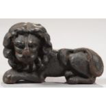 A VICTORIAN CAST IRON MODEL OF A RECUMBENT LION, IN THE ATTITUDE OF COUCHANT GUARDANT, 12.5CM L Good