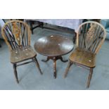 A PAIR OF ASH WHEEL BACK KITCHEN CHAIRS AND A GEORGE III OAK TRIPOD TABLE, 51CM H X 63CM D Table