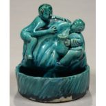 A CHINESE KINGFISHER GLAZED BRUSH WASHER IN THE FORM OF TWO FIGURES SEATED OR CLAMBERING ON A