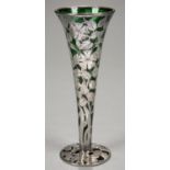 A NORTH AMERICAN SILVER CASED EMERALD GLASS VASE OF TRUMPET SHAPE ON ALMOST FLAT FOOT AND