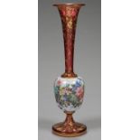 A FRENCH OR BOHEMIAN ENAMELLED OVERLAY GLASS VASE WITH ATTENUATED RUBY GLASS NECK AND FLARED FOOT,