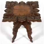AN INDIAN CARVED TEAK OCCASIONAL TABLE ON QUADRUPLE PROFILE LEGS, 45 X 45CM, FIRST HALF 20TH C Good,