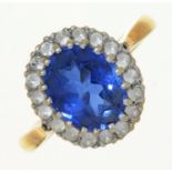 A SYNTHETIC SAPPHIRE AND WHITE STONE OVAL CLUSTER RING, IN 9CT GOLD, 3.1G, SIZE L Good condition