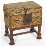 A CONTINENTAL BOARDED WOOD TRUNK COVERED IN CONTEMPORARY BRASS NAILED WOOLWORK, IRON HINGES,