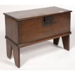 A MINIATURE BOARDED OAK CHEST WITH IRON LOCKPLATE AND HASP, ON TRESTLE ENDS, ELEMENTS GEORGE III AND
