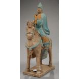 A CHINESE POTTERY FIGURE FUNERARY OF A MOUNTED ARCHER IN HAN STYLE, 31CM H, 20TH C Lower part of bow