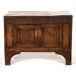 A JOINED OAK CUPBOARD, INCORPORATING A CARVED FRIEZE CENTRED BY INITIALS A S AND DATE 1713, ON