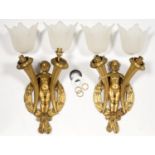 A PAIR OF ART DECO GILT BRONZE FIGURAL WALL LIGHTS IN THE FORM OF A NAKED BOY HOLIDING TWO HORNS