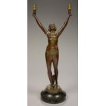 AN ART DECO BRONZED SPELTER FIGURAL LAMP IN THE FORM OF A SEMI NAKED YOUNG WOMAN WITH ARMS UPRAISED,