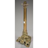 A VICTORIAN BRASS COLUMNAR OIL LAMP ON LEAFY CAST OPENWORK TRIFORM BASE, 48CM H EXCLUDING LATER BULB