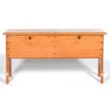 A BOARDED PINE CHEST, DIVIDED IN TWO WITH SIDE-BY-SIDE LIDS, TRESTLE ENDS, 62CM H; 130 X 33CM