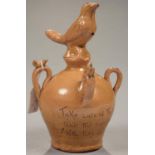 A BRITISH SLIPWARE BANK OF GLOBULAR FORM SURMOUNTED BY A BIRD, FURTHER BIRDS TO THE FOUR SHOULDER