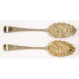 A PAIR OF GEORGE III SILVER TABLE SPOONS, LATER CHASED AND GILT AS BERRY SPOONS, MAKER PROBABLY