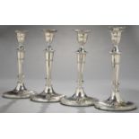 A SET OF FOUR VICTORIAN NEO-CLASSICAL STYLE FLUTED SILVER CANDLESTICKS, ON OVAL FOOT, NOZZLES,