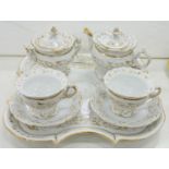 A CONTINENTAL WHITE AND GILT PORCELAIN CABARET SET, THE SHAPED SQUARE TRAY 31CM L, MID 19TH C