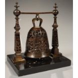 A PARCEL GILT BRONZE BELL, MANNERIST STYLE, WITH CLAPPER, SUSPENDED FROM A BAR BETWEEN PIERCED