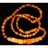 A NECKLACE OF ROUND AND SQUARE AMBER BEADS, 53g Good condition