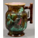 A VICTORIAN MAJOLICA JUG, MOULDED WITH AN EAGLE, BAMBOO HANDLE AND RIM, 23CM H, C1880 Small chip