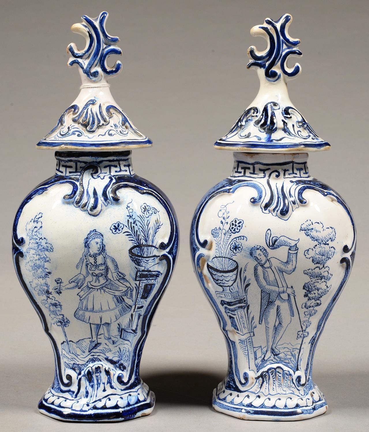 TWO DUTCH DELFTWARE VASES AND COVERS, THE VASES PAINTED WITH A LADY OR GENTLEMAN, 33CM H, 19TH C