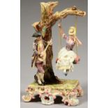 AN EICHLER, ROYAL DUX GLAZED EARTHENWARE GROUP OF LOVERS, THE LADY ON A SWING SERENADED BY A BEAU