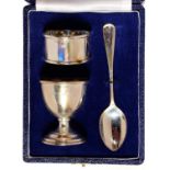 AN ELIZABETH II SILVER CHRISTENING SET OF EGG CUP, SPOON AND NAPKIN RING, EGG CUP 5.5CM H, BY