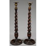 A PAIR OF SPIRAL TURNED OAK CANDLESTICKS WITH BRASS SCONCE AND NOZZLE, ON DISHED FOOT, 46.5CM H,
