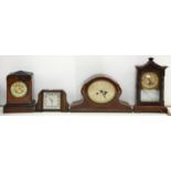 A STAINED WOOD SHELF CLOCK, TWO OTHER MAHOGANY OR STAINED WOOD MANTEL CLOCKS AND A TIMEPIECE,