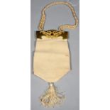 A CONTINENTAL IVORY SILK EVENING BAG WITH GILTMETAL MOUNT AND BRAIDED SILK HANDLE, BAG 21CM H