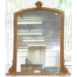 A VICTORIAN GILTWOOD AND COMPOSITION OVERMANTEL MIRROR, THE LOW ARCHED FRAME WITH PALMETTE CREST,