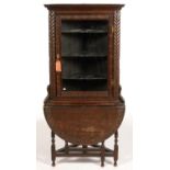 A VICTORIAN CARVED AND DARK STAINED OAK CORNER CABINET ON TRIANGULAR DROP LEAF STAND, 183CM H; 87
