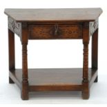 A REPRODUCTION OAK CREDENCE TABLE WITH CARVED FRIEZE AND UPRIGHTS, 60CM H; 40 X 75CM Top water