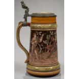 A MUSICAL PEWTER MOUNTED METTLACH STEIN, THE COVER ENGRAVED WITH PRESENTATION INSCRIPTION AND