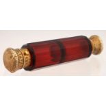 A VICTORIAN GILT SILVER COLOURED METAL MOUNTED RUBY GLASS DOUBLE ENDED SCENT-AND SALTS-BOTTLE,