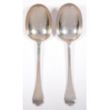 TWO MATCHING EDWARD VII SILVER SERVING SPOONS, TREFID PATTERN WITH RAT TAIL, BY HOLLAND,