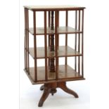 AN EDWARDIAN OAK ROTATING BOOK STAND, 105CM H; 53 X 53CM, C1910 Top split