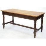 A RECTANGULAR STAINED WOOD TABLE WITH OAK TOP ON TURNED LEGS UNITED BY PEGGED STRETCHERS, 79CM H; 70