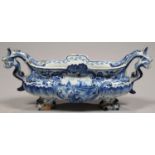 A DUTCH DELFTWARE DOLPHIN-HANDLED MINIATURE JARDINIERE, PAINTED TO EITHER SIDE WITH A SHIPPING