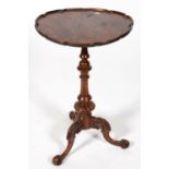 A VICTORIAN WALNUT TRIPOD TABLE, 70CM H; 44CM DIA The associated top slightly warped and stained