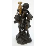 A VENETIAN CARVED AND EBONISED WOOD GROUP OF THREE PUTTI, ONE HELD ALOFT BY THE OTHERS AND
