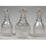 ONE AND A PAIR OF ENGLISH CUT GLASS DECANTERS WITH THREE NECK RINGS AND DIAMOND CUT BANDS,