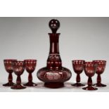 A BOHEMIAN RUBY FLASHED AND FACET CUT GLASS DECANTER AND STOPPER AND SIX WINE GLASSES EN SUITE,