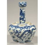 A CHINESE BLUE AND WHITE VASE, WITH ARTICHOKE NECK AND FIVE FURTHER APERTURES PAINTED WITH