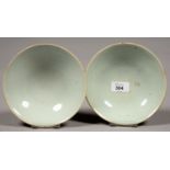TWO CHINESE PALE CELADON GLAZED BOWLS, 16CM DIA, APOCRYPHAL REIGN MARK, 19TH C Minor chips and rim