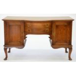 A BOW CENTRED OAK SIDEBOARD WITH BRASS DROP HANDLES, ON CABRIOLE LEGS, 93CM H; 57 X 152CM, C1910