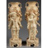 A PAIR OF AUSTRIAN OLD IVORY GROUND EARTHENWARE VASES,OF SLENDER TWO HANDED FORM THE RUSTIC BASE SET