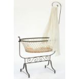 A FRENCH IRON BABY'S CRADLE WITH OVAL FRAME AND STRUNG BASKET, 174CM H X 118CM L Good condition